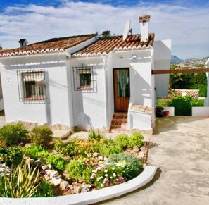 Front of the villa with garden and ample car parking available.