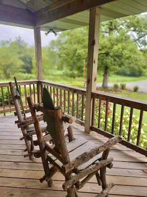 Lots of outdoor space to enjoy the lush green setting from this 3/4 wraparound porch