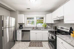 Kitchen elegance: Brand new stainless steel appliances for a sleek, modern cooking experience.