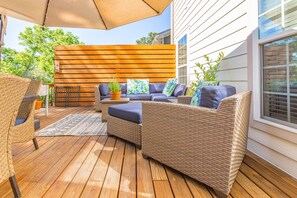 Back deck includes sitting area and dining table for 6