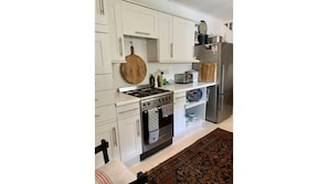 Kitchen, with Smeg cooker, large fridge/freezer, and dishwasher.