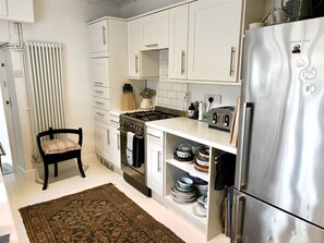 Smeg cooker, well stocked kitchen with plenty of crockery and utensils.