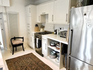 Smeg cooker, well stocked kitchen with plenty of crockery and utensils.