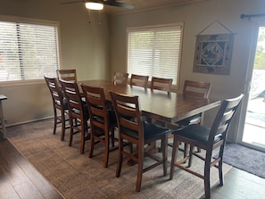 Large dining table with light and fan above.