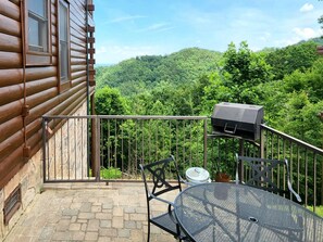 Small patio with charcoal grill.