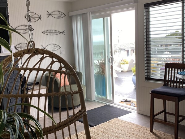 Overlooking the Pacific Ocean is the deck with chairs + tables.