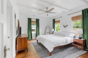 Primary bedroom with king bed, smart TV, and an ensuite bathroom