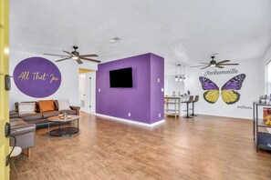 Spacious living room for your group with a butterfly mural