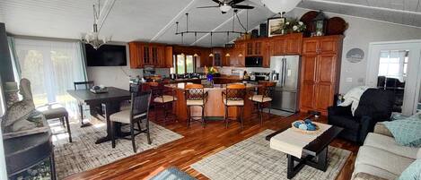 extra large kitchen with dining table for 6, 4 bar stools and the couch to relax