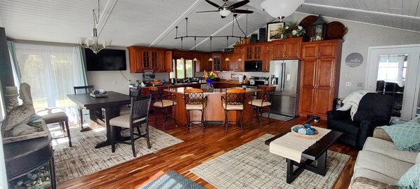 extra large kitchen with dining table for 6, 4 bar stools and the couch to relax