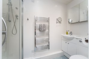 The ensuite features a walk in shower and heated towel rail
