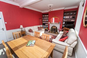 The living/dining area boasts an open fire