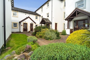 The entrance to the property is located in the courtyard just beyond the car park