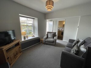 The living room is a bright and spacious area with lovely views thanks to its elevated position