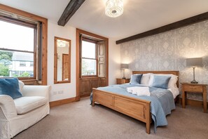 The master suite provides a king-sized bed, large wardrobe and drawers