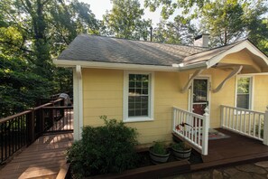 Side deck has gate to keep dogs in, gas grill, table, chairs, umbrella.