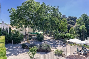 Garden with walnut trees, owners' house and rental cottages in the background