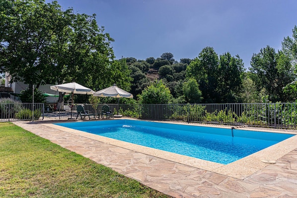 Fully-enclosed private pool, 10m x 5m with loungers, parasols, tables and chairs