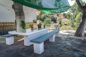 Shady dining area with BBQ