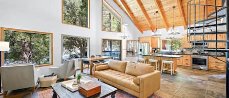 Open concept living room looking out on the beautiful forest. 