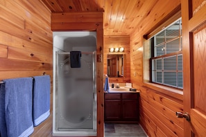 The bathroom features a standing shower