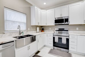 Upgraded kitchen with quartz countertop.