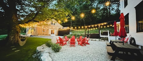 Gather outside to enjoy the fire pit, hot tub, corn hole and barn game room.