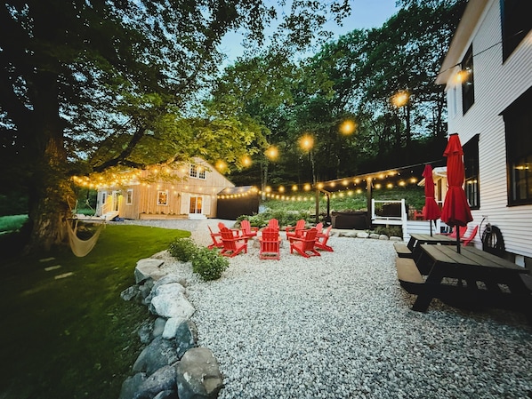 Gather outside to enjoy the fire pit, hot tub, corn hole and barn game room.