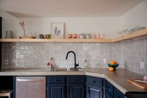 Fully Equipped Kitchen w Custom Concrete Countertops + Open Shelving