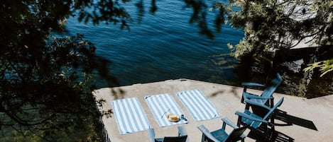 Enjoy your coffee in the sunshine on our concrete dock - spanning 150 feet of waterfront and featuring incredible East facing views of Crown Land, islands, and beautiful cottages on Charleston Lake.