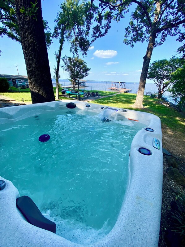 Relax in our hot tub while gazing over the lake…