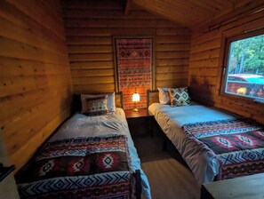 Bedroom 2 with 2 single beds, drawers and mirror