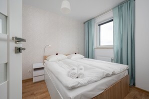 Bedroom with a comfortable double bed, soft lighting, and modern decor.
