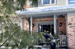 Relaxing front porch, set in a natural landscape. 