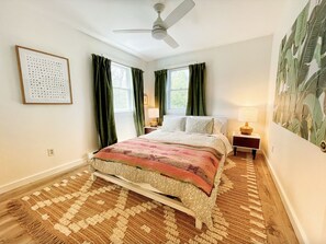 Master bedroom with queen bed and view of the trees. 