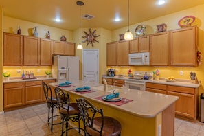 Bright and spacious kitchen has island seating for coffee, snacks and nightcaps.