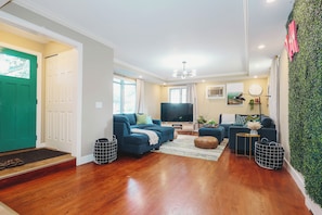 Our main living room in the back features two large sofas and a 65" Roku TV