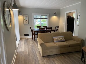 Open concept living and dining room. Note, couch does pull out to a queen. 