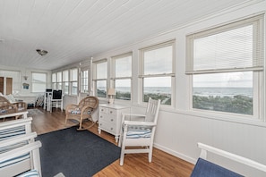 Relax and take in ocean views and the beach from the enclosed porch