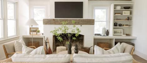 Wood burning fireplace, Samsung Frame Smart TV and authentic barn wood beams 