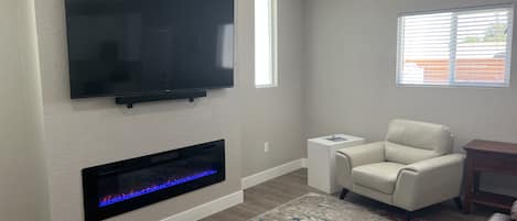 Electric fireplace and 75” smart TV