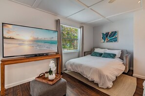In the cozy living area of this studio unit, you'll find a stylish grey sofa bed that serves as both a comfortable seating option and a convenient sleeping arrangement.