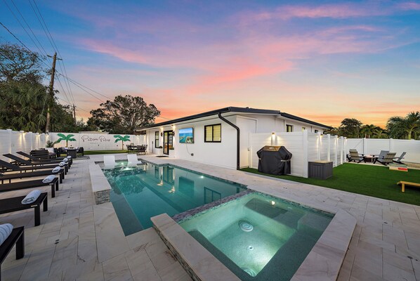 The backyard includes a heated saltwater pool and spa, putting green, and more!