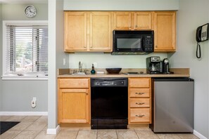 Our full kitchen is fully equipped with all the essentials you need for culinary adventures, including a coffee maker, stove top, dishwasher, microwave, toaster, pots, pans, tea towels, cooking utensils, silverware, and more. It's a hub of culinary creativity and convenience for your stay.
