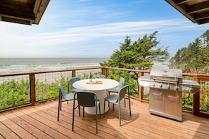 Enjoy grilling/BBQ and dining outside on the large patio with views of the trees and ocean.