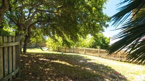 Large fenced in back yard is safe for kids & dogs with motion activated lights.