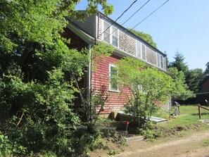 across private road (outdoor shower to the left), seen from parking area