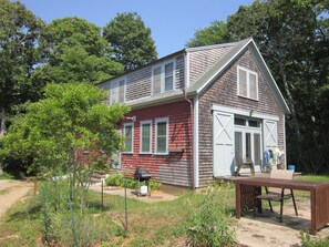 note gas grill and retractable clothesline next to house
