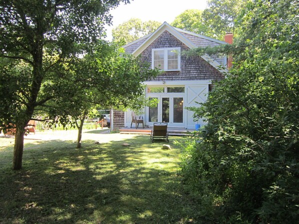 view from dirt road approaching barn; note parking area in left background