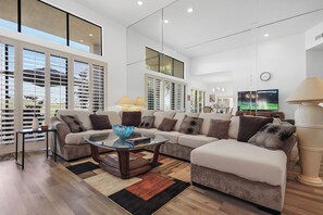 Living room with 65" Samsung Smart TV, Cable TV, Wet bar and Golf course view
